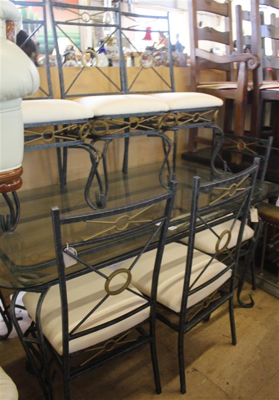 Set of six wrought iron framed dining chairs and matching plate glass topped table